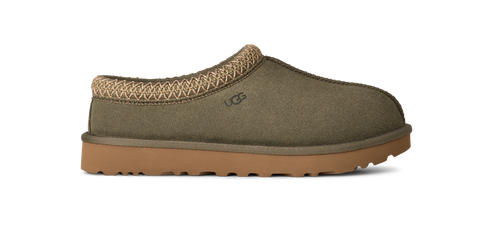 A green slip-on shoe with tan trim and a tan sole.