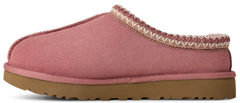 A pink slipper with a tan sole and a white and tan decorative band around the opening.