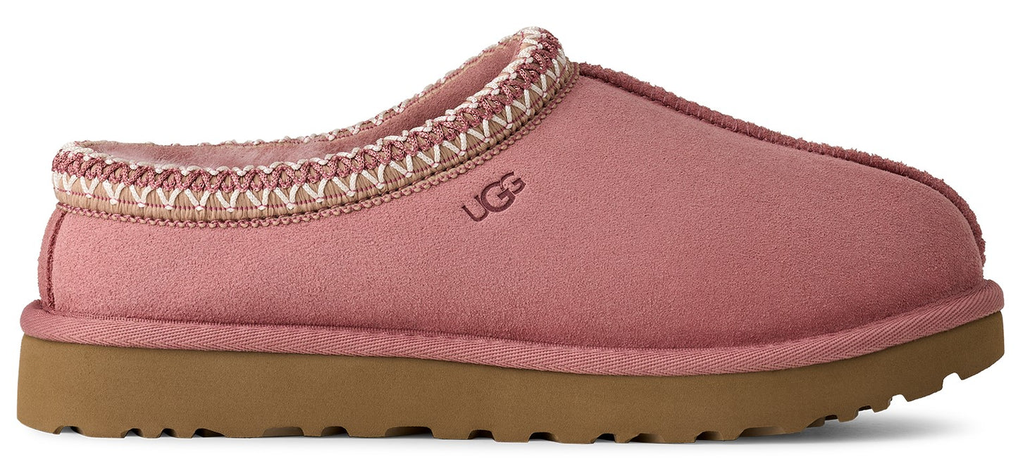 A pink UGG slipper with a brown sole and decorative stitching.