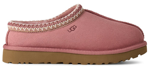 A pink UGG slipper with a brown sole and decorative stitching.