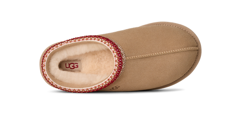 Top-down view of a brown slip-on shoe with a red and cream braided trim.
