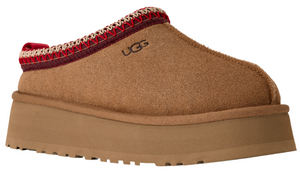 Tan UGG slipper with red and white knit detail and thick platform sole.