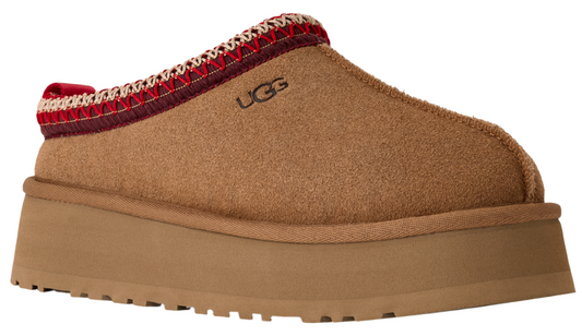 Tan UGG slipper with red and white knit detail and thick platform sole.