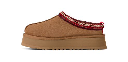 A brown mule shoe with a thick platform sole and a red and white trim.