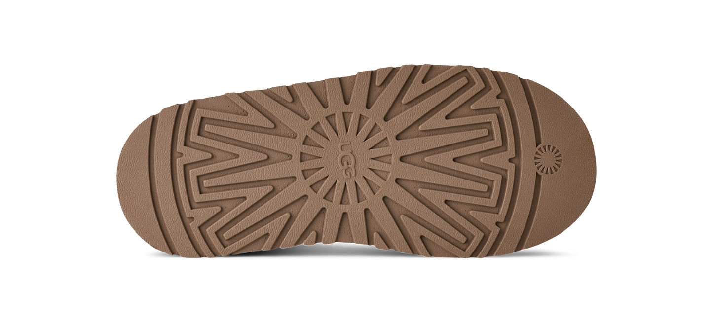 Tan UGG sole with textured pattern.