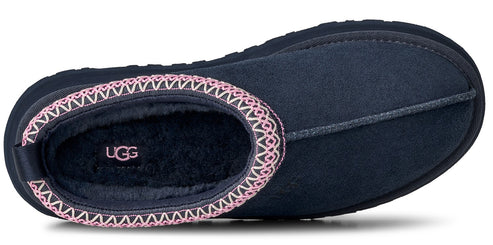 Low angle view of navy slipper with pink decorative trim.
