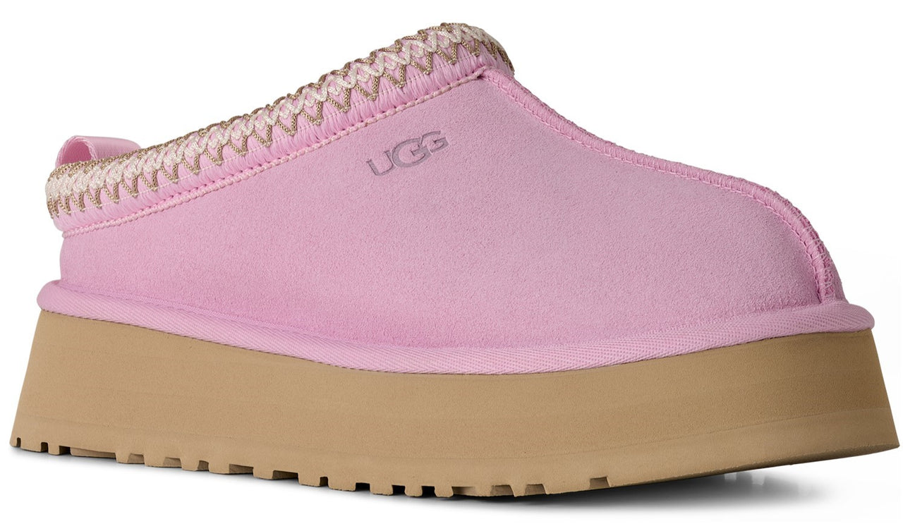 Pink slip-on shoe with a thick, tan platform sole and textured trim.