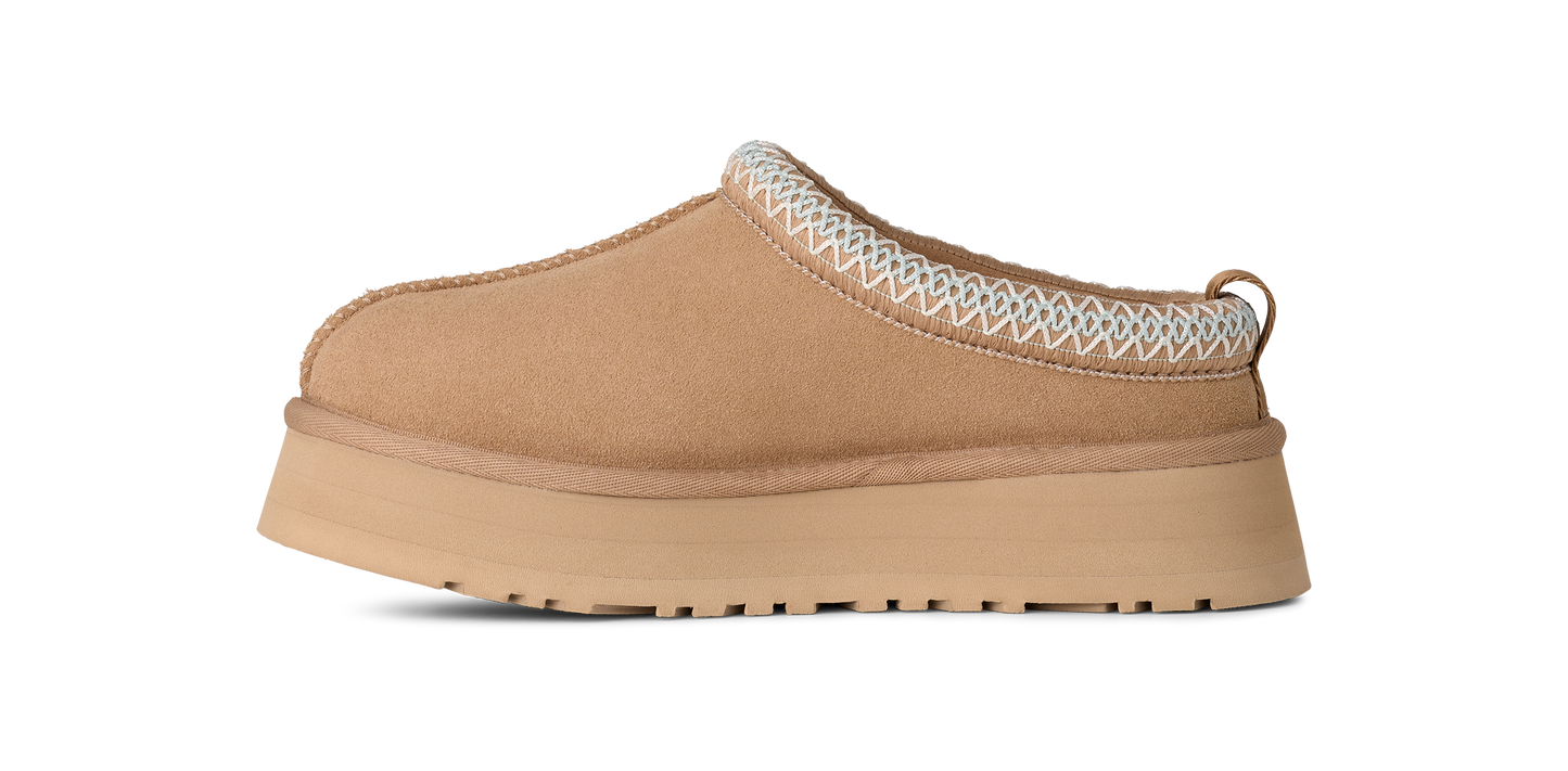 Tan slip-on platform shoe with zig-zag trim.