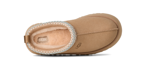 Tan colored slip-on shoe with decorative white stitching.