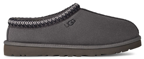 Gray UGG slipper with decorative trim.