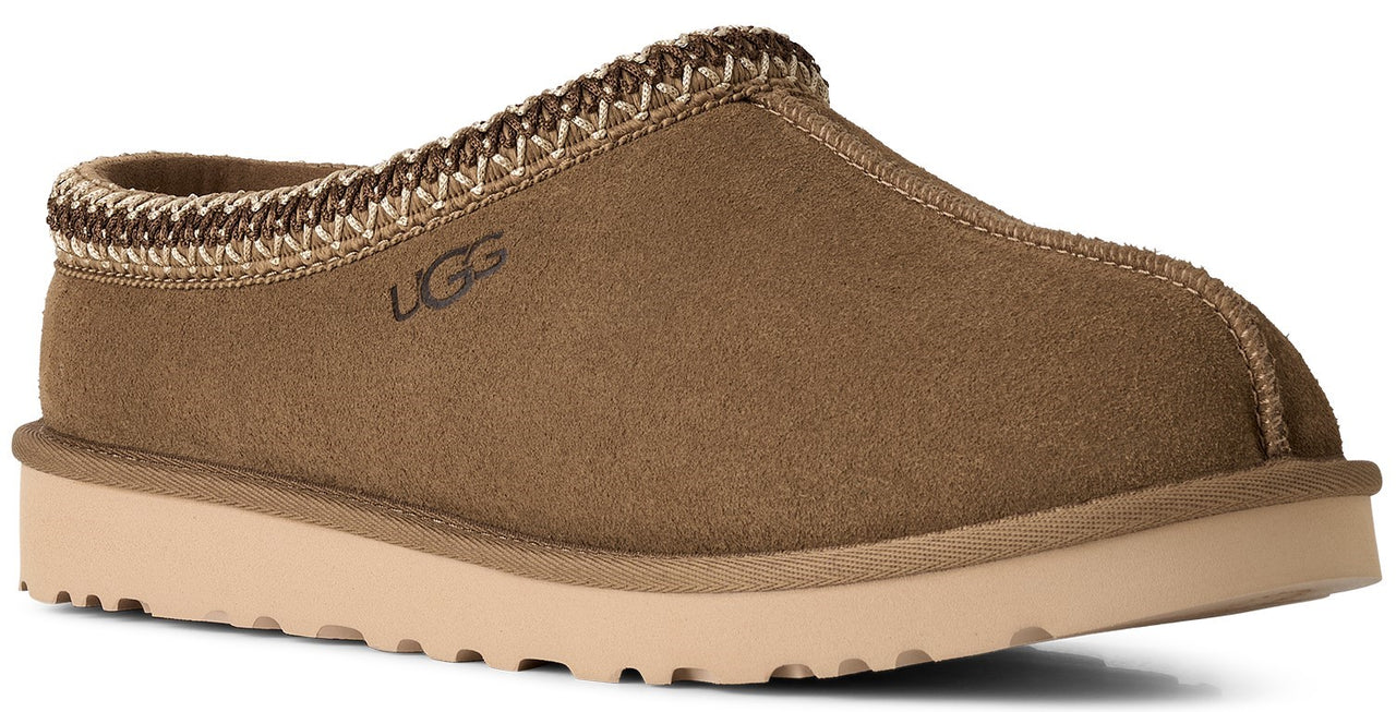 A brown suede slip-on slipper with a beige platform sole and a decorative woven braided trim around the opening, featuring the UGG logo embossed on the side.