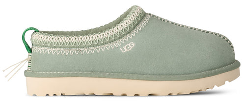 Light green UGG slip-on shoe with white trim and sole, and a green pull tab.