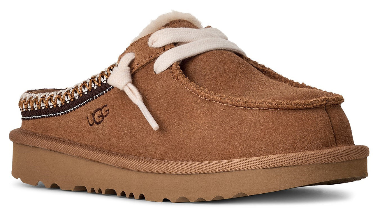 Brown suede slipper with visible white laces and woven detailing along the back.