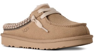 Tan suede clog-style slipper with decorative laces and UGG logo.