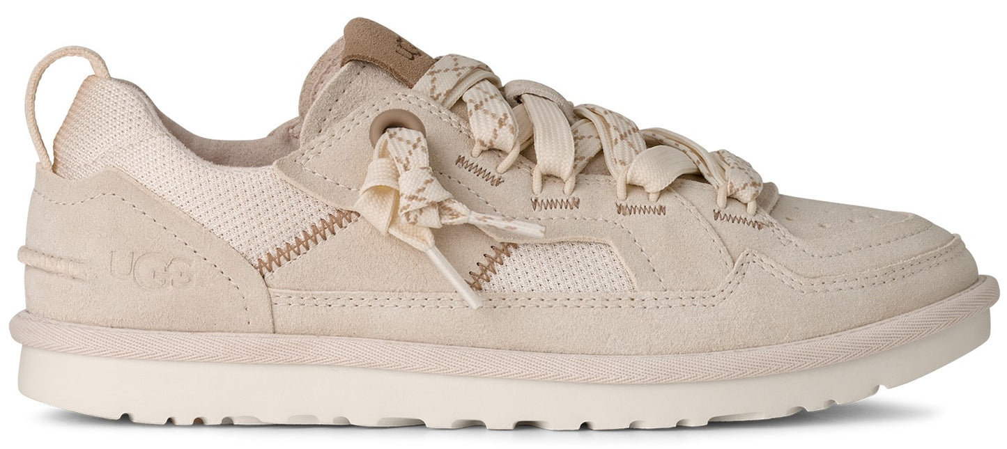 A beige sneaker with thick laces.