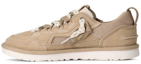 A tan sneaker with white soles and patterned laces.