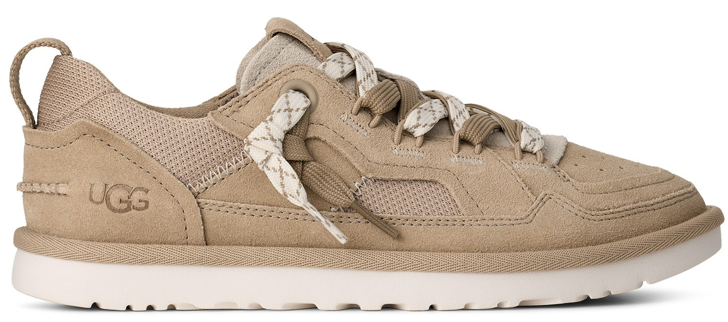 A tan-colored sneaker with white laces and a white sole.