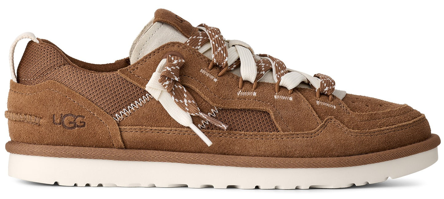 A brown low-top shoe with a white sole and brown and white laces.