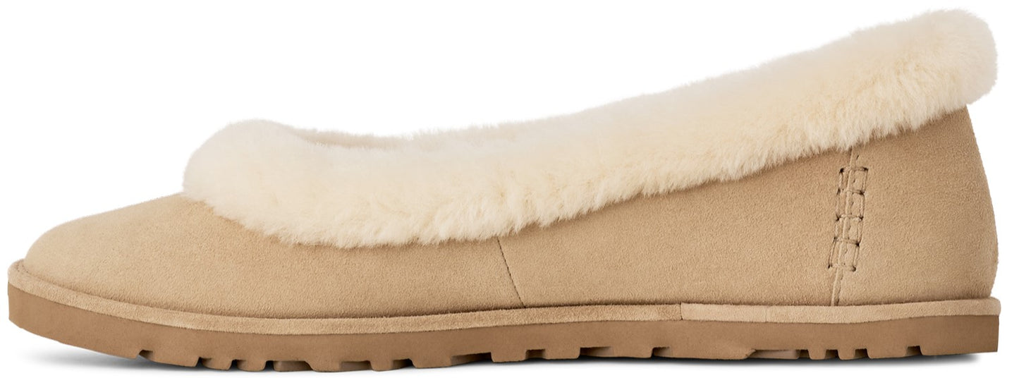 A tan suede slip-on slipper with a fluffy cream-colored shearling collar and a flat, textured rubber sole.