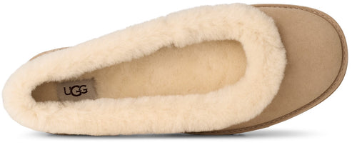 A tan suede slipper with a plush cream-colored shearling lining and a visible UGG logo on the heel.