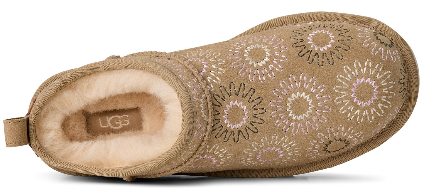 Tan-colored ankle-high boot with floral pattern and fur interior.