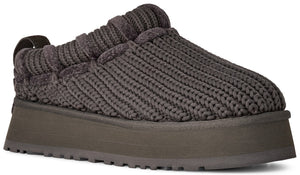 A dark charcoal gray slip-on shoe featuring a thick, braided, cable-knit upper material and a chunky, flat-bottomed platform sole.