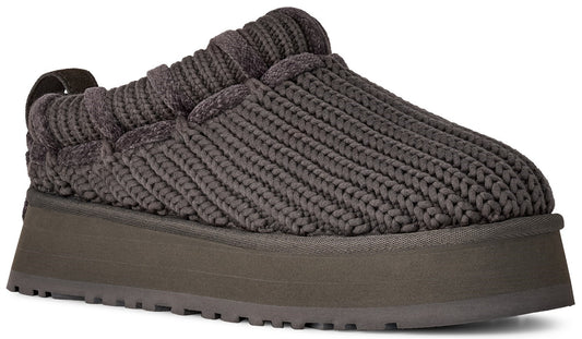 A dark charcoal gray slip-on shoe featuring a thick, braided, cable-knit upper material and a chunky, flat-bottomed platform sole.