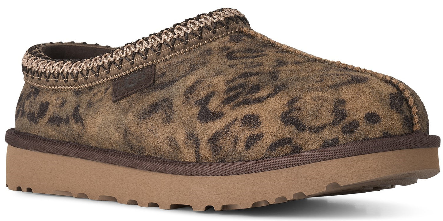 A slip-on slipper with a brown leopard print suede upper, a tan rubber platform sole, and a decorative braided trim around the opening.