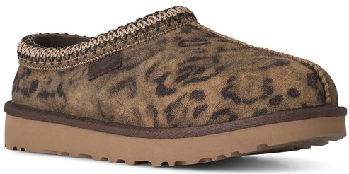 A slip-on slipper with a brown leopard print suede upper, a tan rubber platform sole, and a decorative braided trim around the opening.