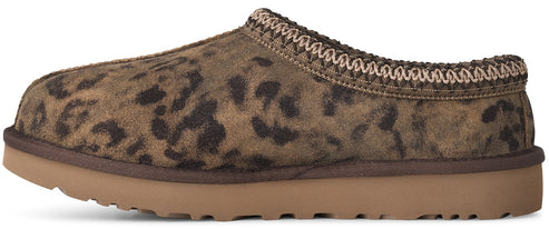 A slip-on slipper with a brown leopard print suede upper and a thick, gum-colored rubber sole, featuring a decorative braided trim around the collar.