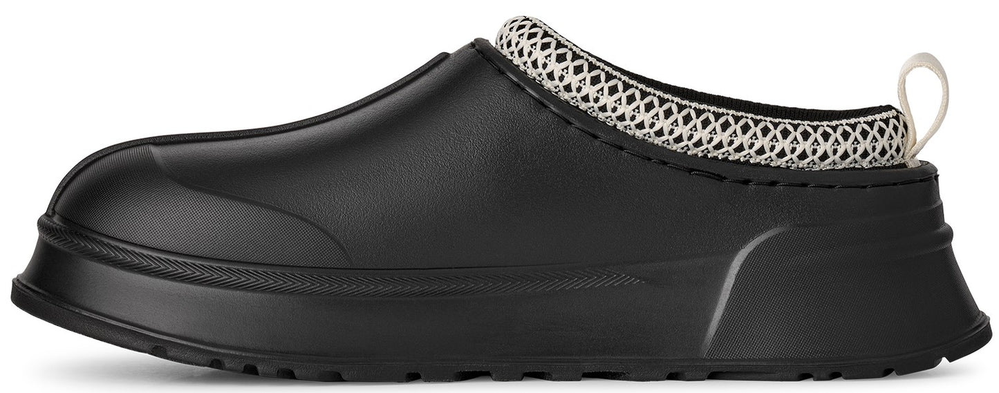 A black slip-on clog with a smooth, rounded rubber-like upper, a thick black sole, and a white and black woven mesh collar with a small heel pull loop.