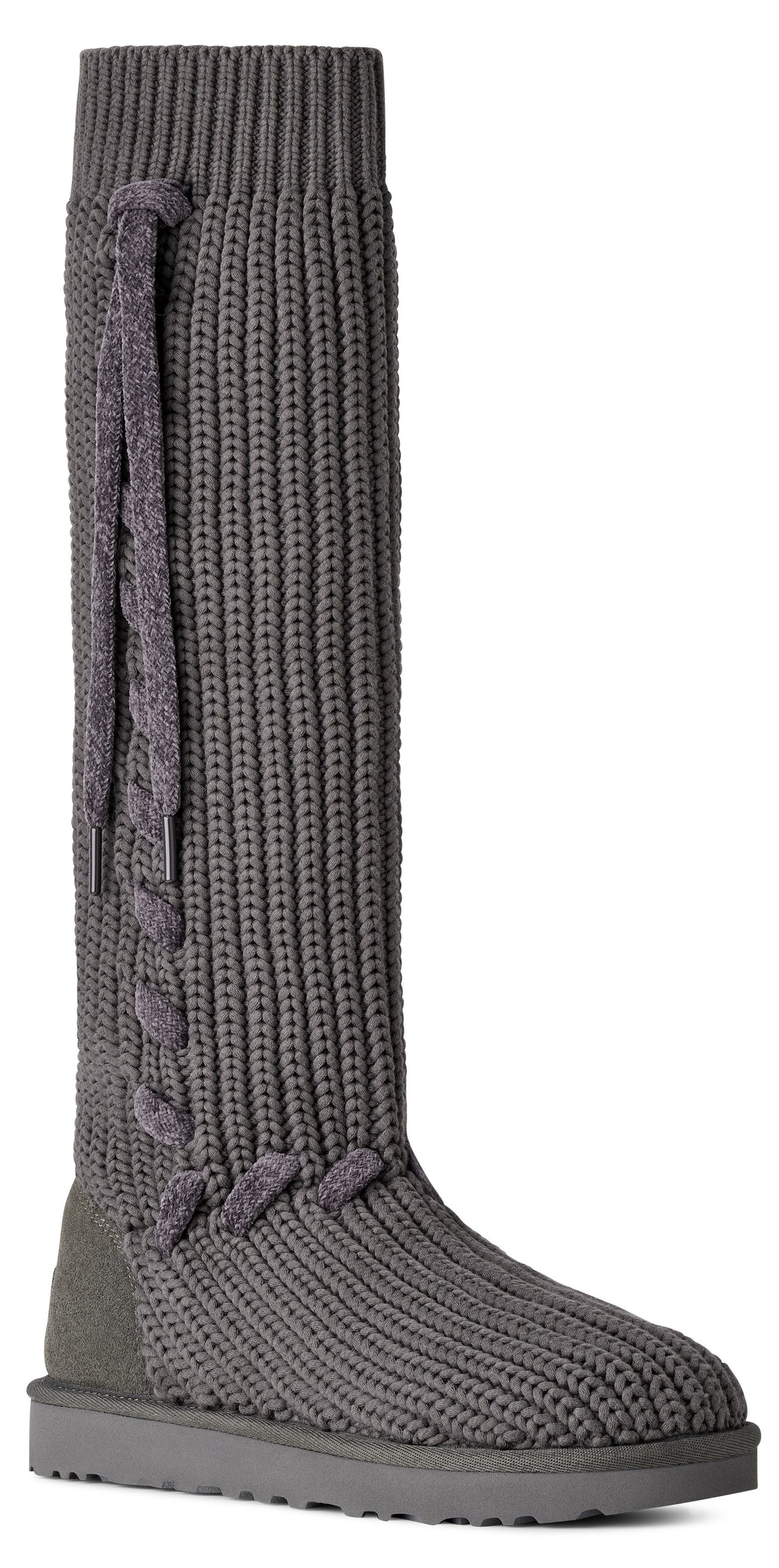 A gray, knee-high, ribbed knit boot with a suede heel counter and a lace-up detail along the side shaft.