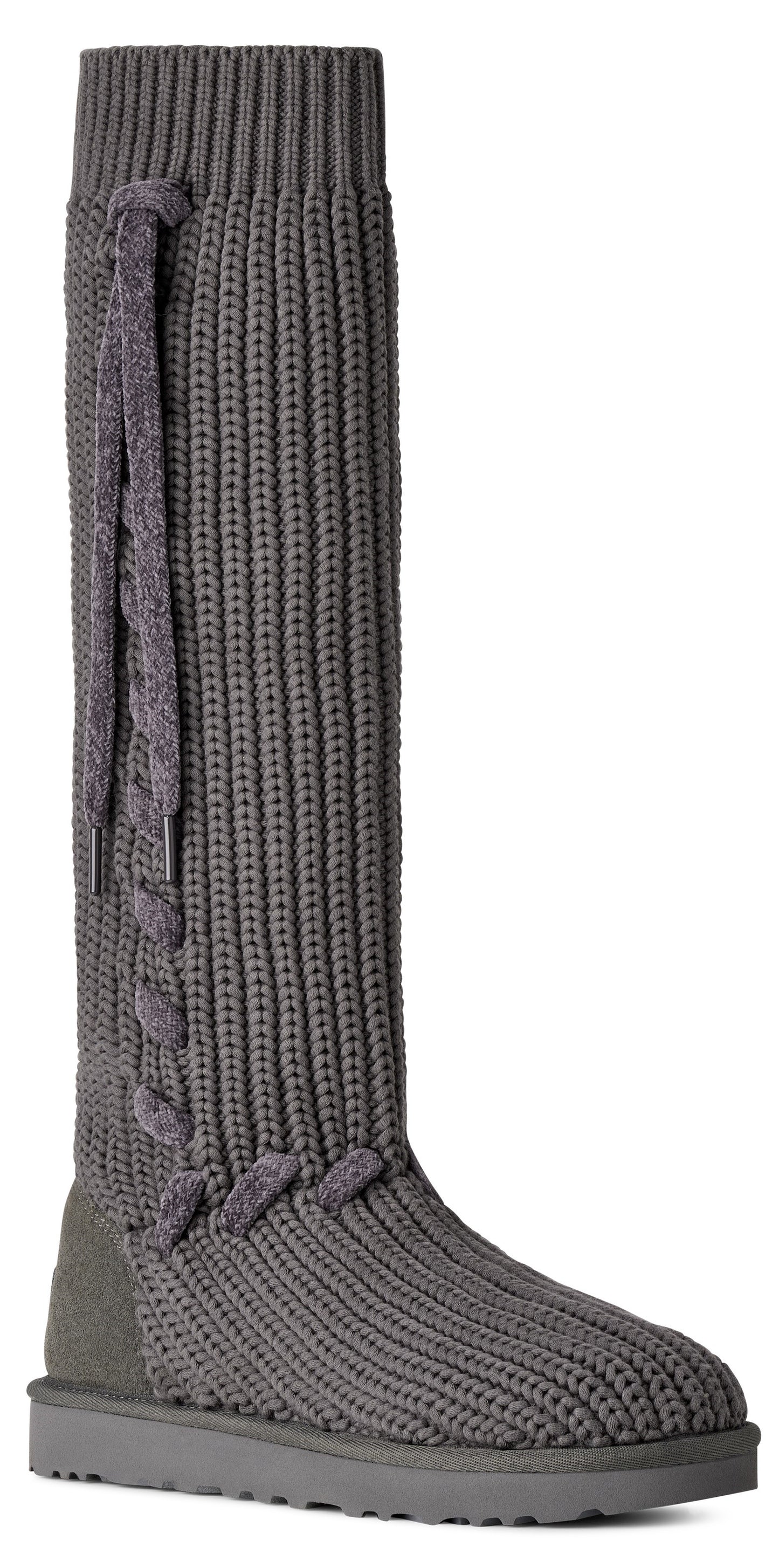 A gray, knee-high, ribbed knit boot with a suede heel counter and a lace-up detail along the side shaft.