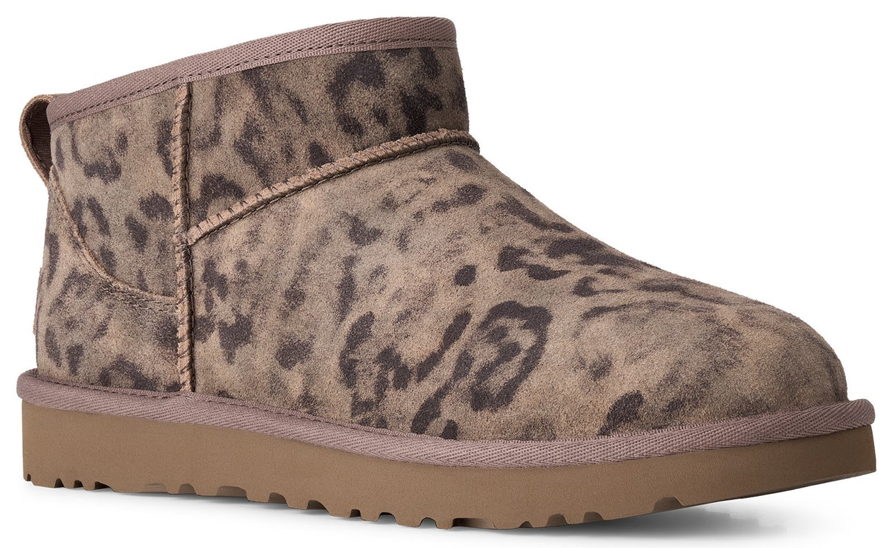 An ankle boot featuring a brown leopard print suede upper, a tan rubber sole, and stitched seam details.