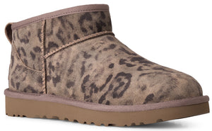 An ankle boot featuring a brown leopard print suede upper, a tan rubber sole, and stitched seam details.