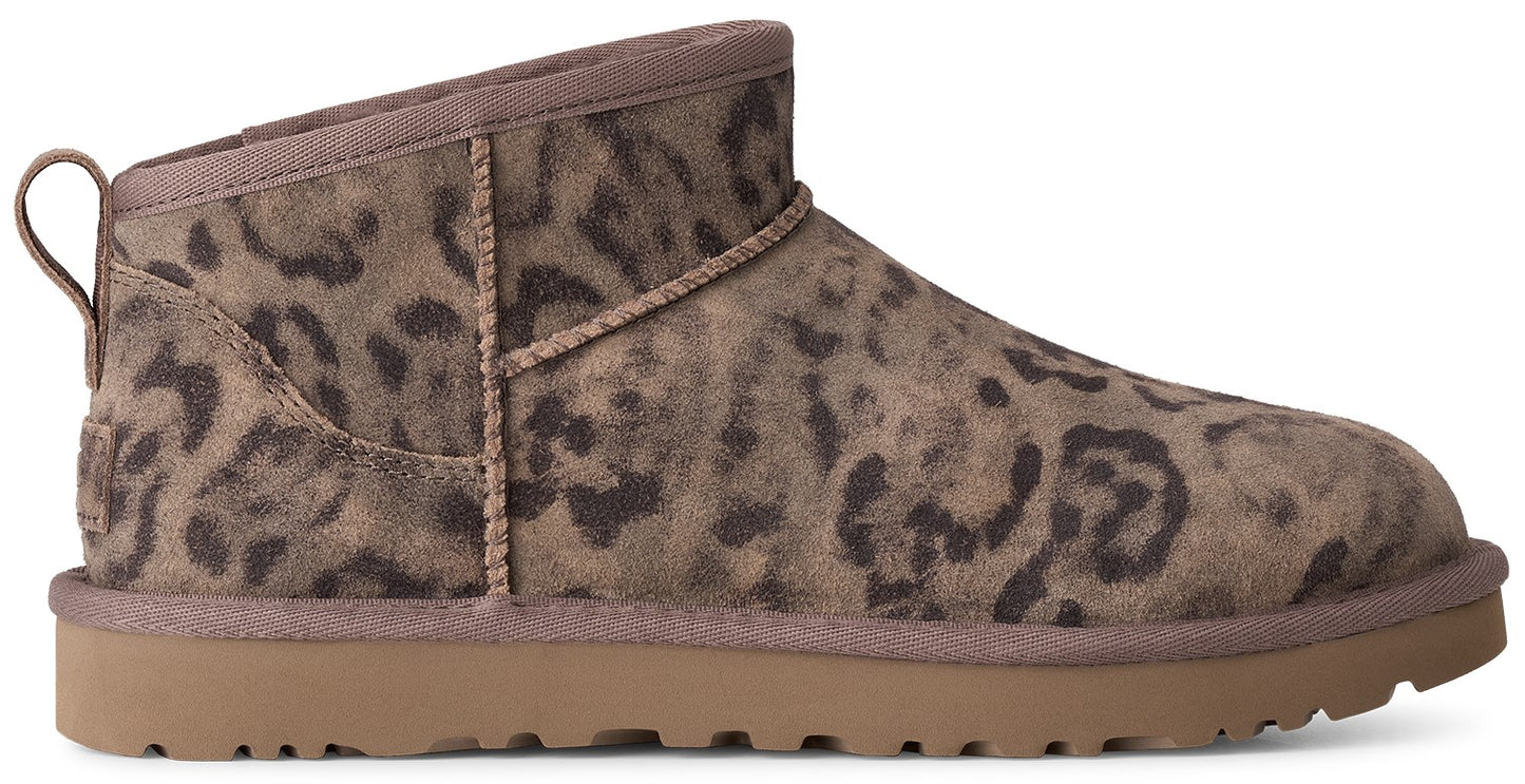 A low-profile ankle boot featuring a suede upper with a dark brown leopard print pattern and a solid tan rubber sole with a textured tread.