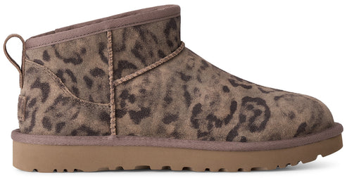 A low-profile ankle boot featuring a suede upper with a dark brown leopard print pattern and a solid tan rubber sole with a textured tread.