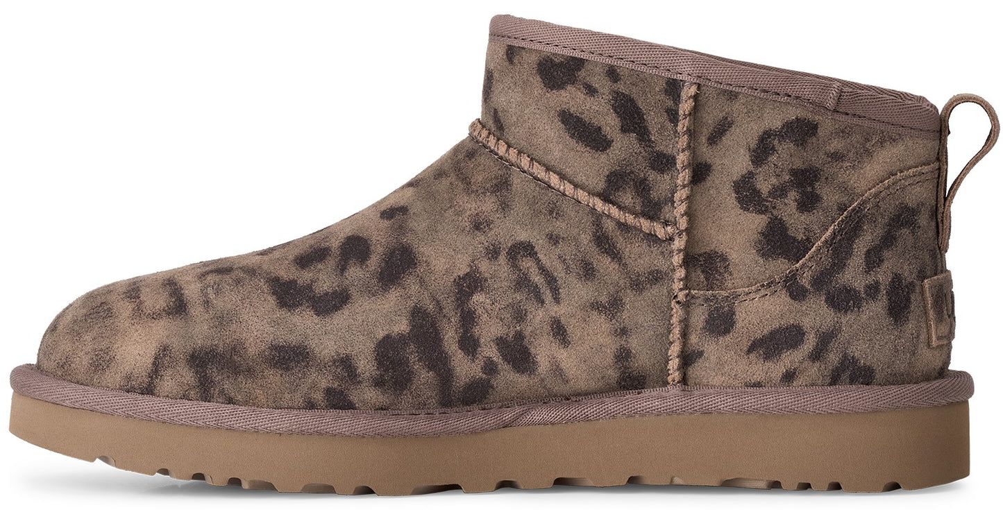 A leopard print suede ankle boot with a thick brown rubber sole and a pull tab on the heel.