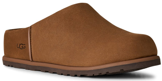 A brown suede slip-on mule shoe with a rounded toe, a textured rubber sole, and the logo UGG embossed on the side.