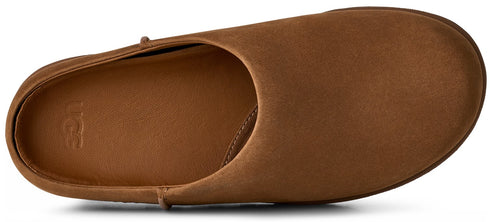 A tan suede slip-on shoe seen from a top-down angle, featuring a smooth rounded toe and an UGG logo debossed on the insole.