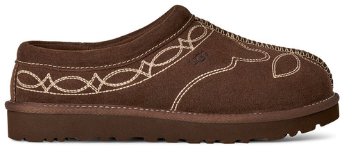 A dark brown suede slip-on shoe featuring western-style light-colored decorative stitching patterns along the side and a small debossed UGG logo on the mid-section, set on a thick matching brown sole.
