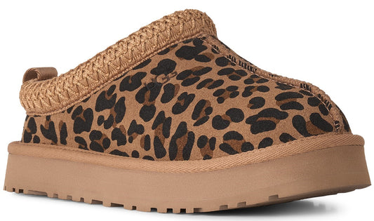 A slip-on shoe with a tan-colored platform sole, featuring a tan suede upper with a black leopard print and a thick, braided tan collar.