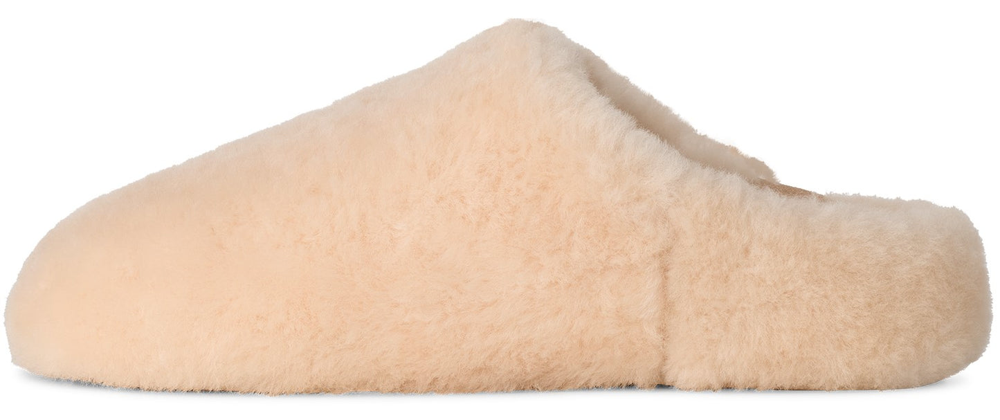 A beige, plush, slip-on slipper made of soft, textured faux fur.