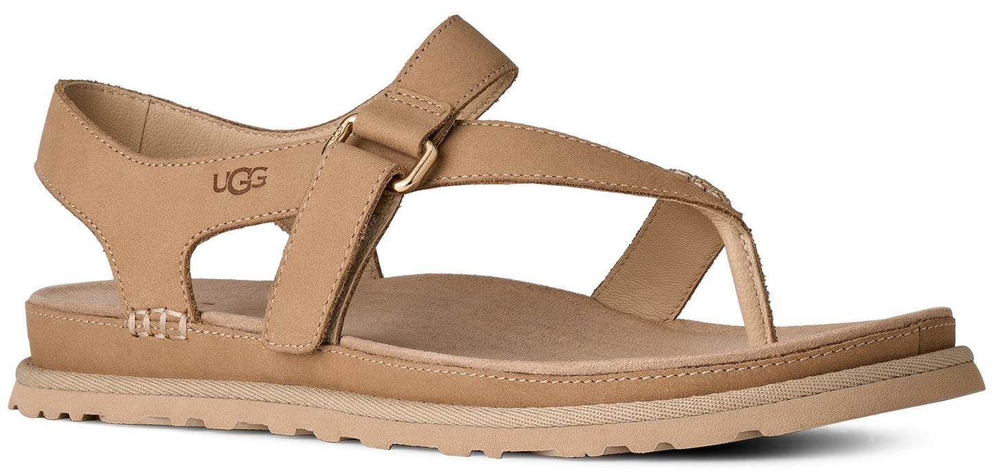Tan sandal with a strap across the top and a heel strap. The UGG logo is on the side of the heel.