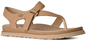Tan sandal with a strap across the top and a heel strap. The UGG logo is on the side of the heel.