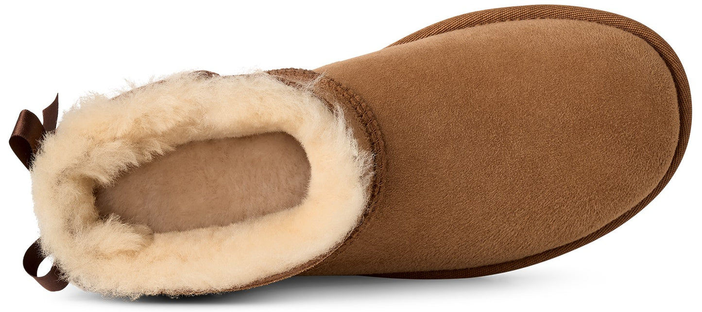 A tan suede boot shown from a top-down view, featuring a plush cream-colored shearling lining and a small brown bow detail at the heel.