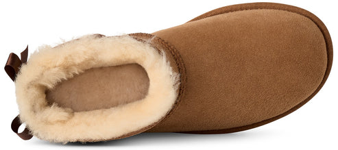 A tan suede boot shown from a top-down view, featuring a plush cream-colored shearling lining and a small brown bow detail at the heel.