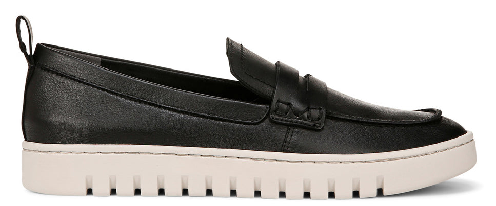 A black penny loafer with a thick white sole and a small loop at the back of the heel.