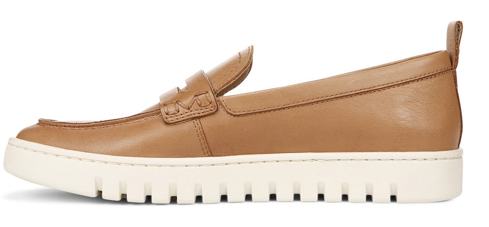 A tan-colored leather loafer with a white sole.