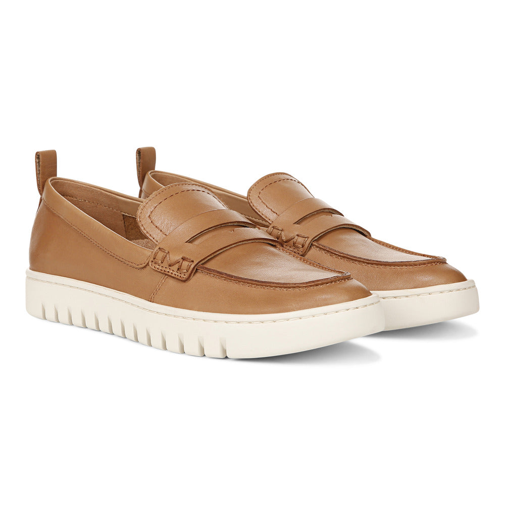 Pair of tan-colored leather penny loafers with white soles.